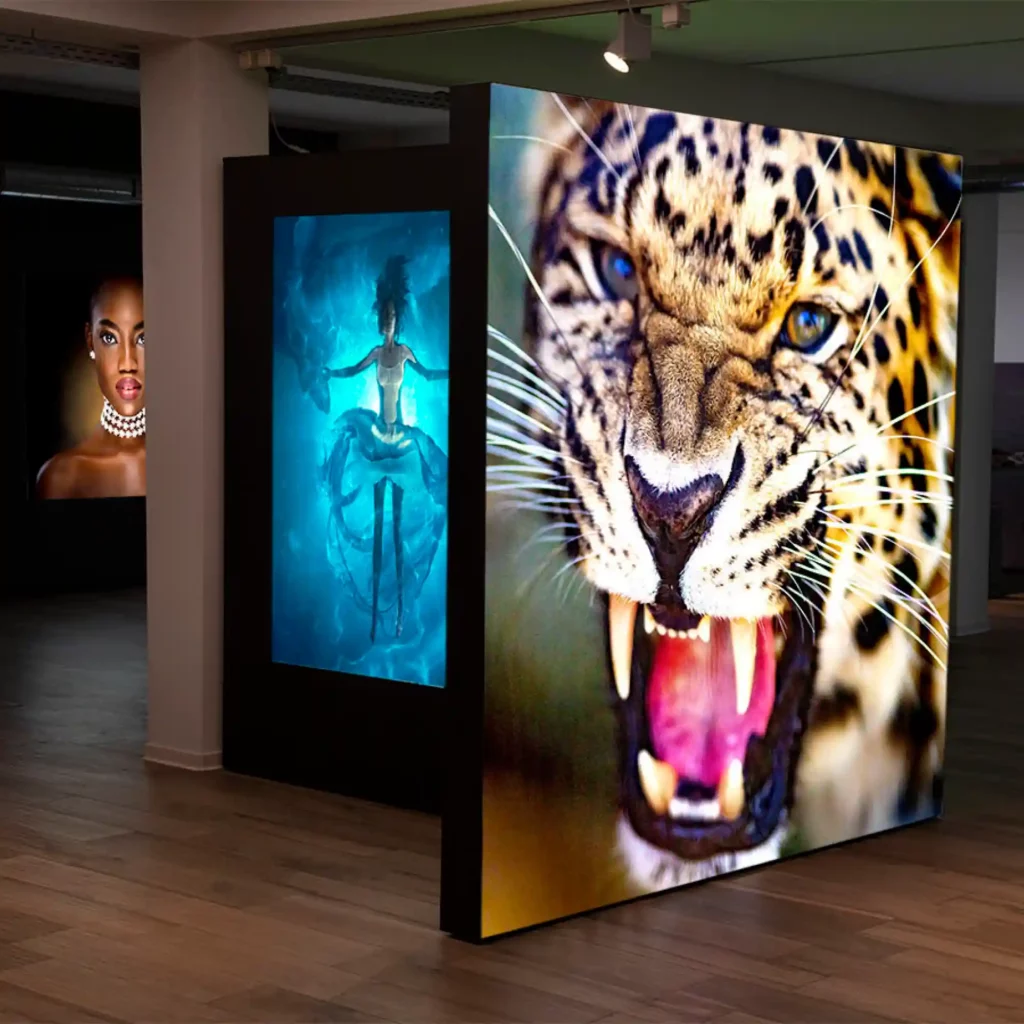 KREA Speedy 911-11 backlit tension display framed exhibition display prints fixed in large format wall-to-ceiling lightboxes within a low light room which allows the printed graphics to shine with the vibrant colours and deep blacks a real stand out, appealing feature.