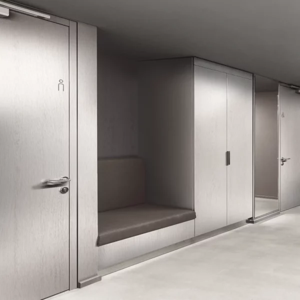 LX BENIF RGM Solid Patten interior films cover the doors, walls and seating alcoves of this cloakroam waiting area, with the dominant featured film being a light grey woodgrain textured pattern, complimented by darker grey soft furnishings and cushions.