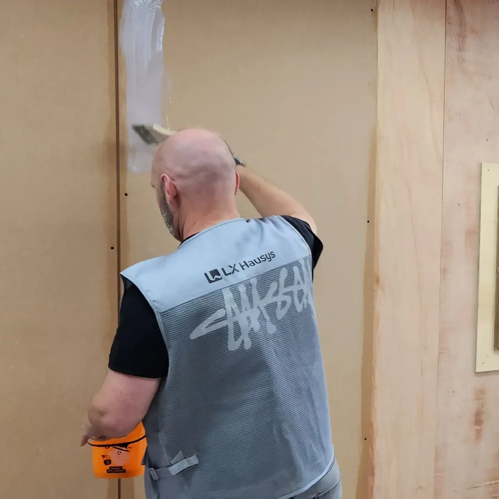 In the process of fully priming a bare wall surface pre-application of LX Hausys self-adhesive interior film.