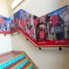 M11-H-P print vinyl with HighGRAB UV acrylic adhesive bonds well to difficult to stick to surfaces, which is why it is popular choice for wall graphics like the image shows here, used as a printed wall graphic that decorates this school staircase with an educational, history themed print applied to follow the contours of the bannister rails.