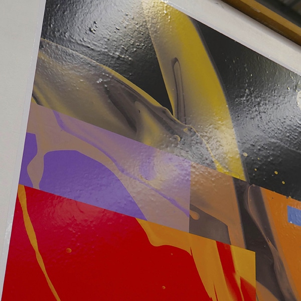 M12-H-K(N) and M16-H-K(N) new matt and gloss vinyl products printed with a bright coloured geometric abstract image and stuck on a roughly plastered 1D, flat wall surface.