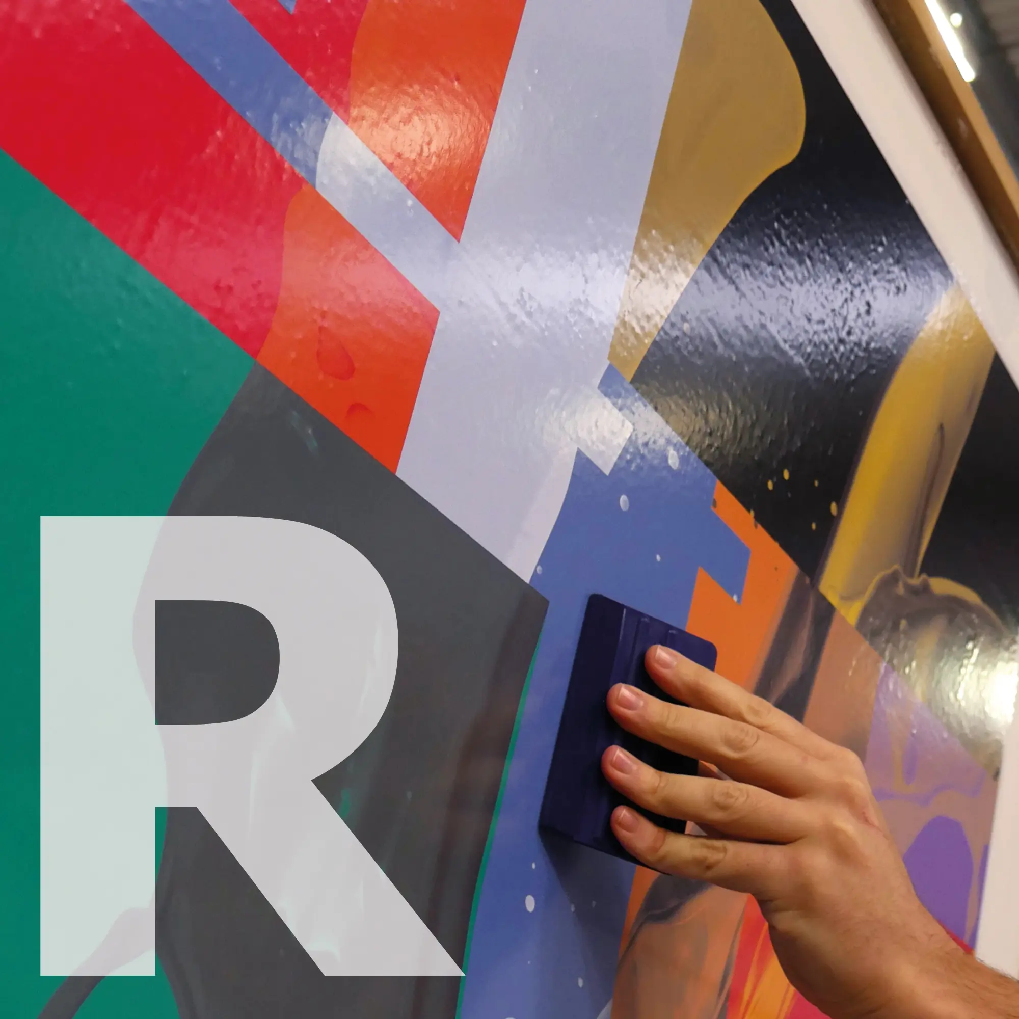 M12-R-P gloss white monomeric print vinyl with removable adhesive being applied to a wall surface with a felt edged squeegee, with the graphic intended as a temporary wall poster which can then be easily removed within 1 year and leave no adhesive residue.... quick and easy clean up ready for the next set of self-adhesive graphics.