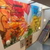 M15-H HighGRAB self-adhesive wide-format vinyl is shown here printed with a brightly coloured graphic design that uses text and line art images to display this school's values of "commitment", "forgiveness", "love", "truth" and "respect" and it has been applied to cover across multi-levels of this school reception wall.