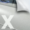 M21-P-X self-adhesive, bubble-free gloss clear print film being printed with white ink in a floral, alkor alba style pattern for application as a window print graphic. The top right corner of the picture includes a superimposed graphic with a folded down corner and cross-hatched lines that depict the embossed air release liner characteristic of this monomeric graphics film.