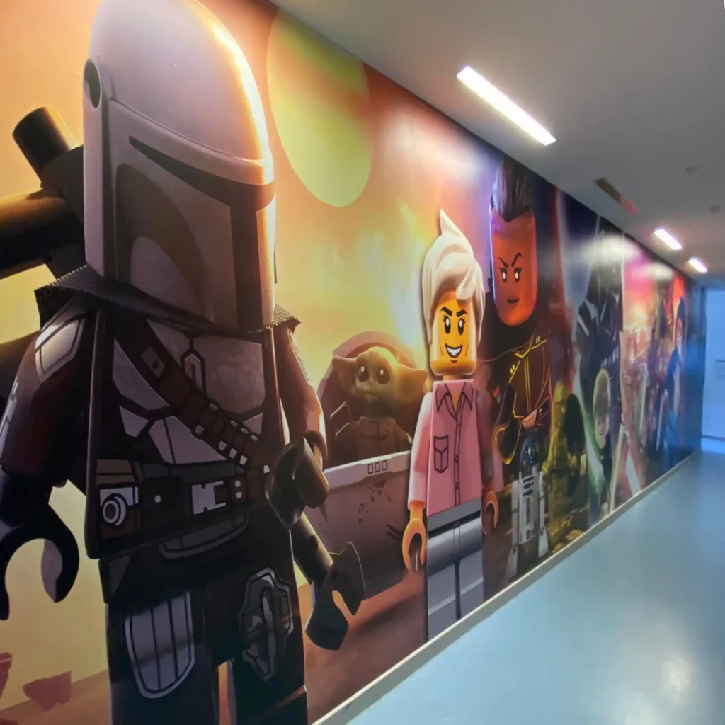 M25-P-K transparent matt clear print vinyl and printable laminate has been used to overlaminate M16-H printing film to protect the printed graphic on this school corridor wall covering of ultra large sized lego characters from the Star Wars, Mandalorian series.
