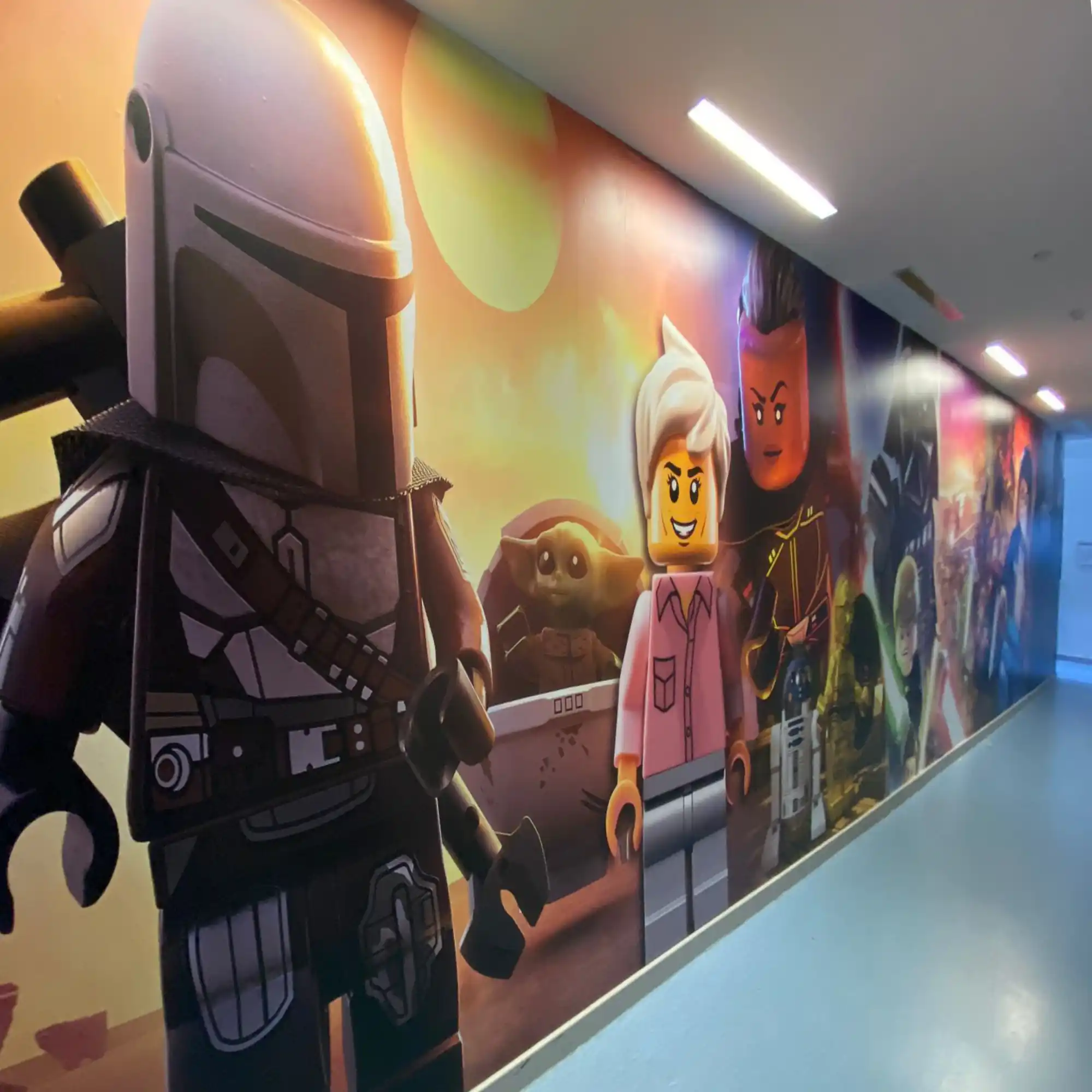 M25-P-K transparent matt clear print vinyl and printable laminate has been used to overlaminate M16-H printing film to protect the printed graphic on this school corridor wall covering of ultra large sized lego characters from the Star Wars, Mandalorian series.
