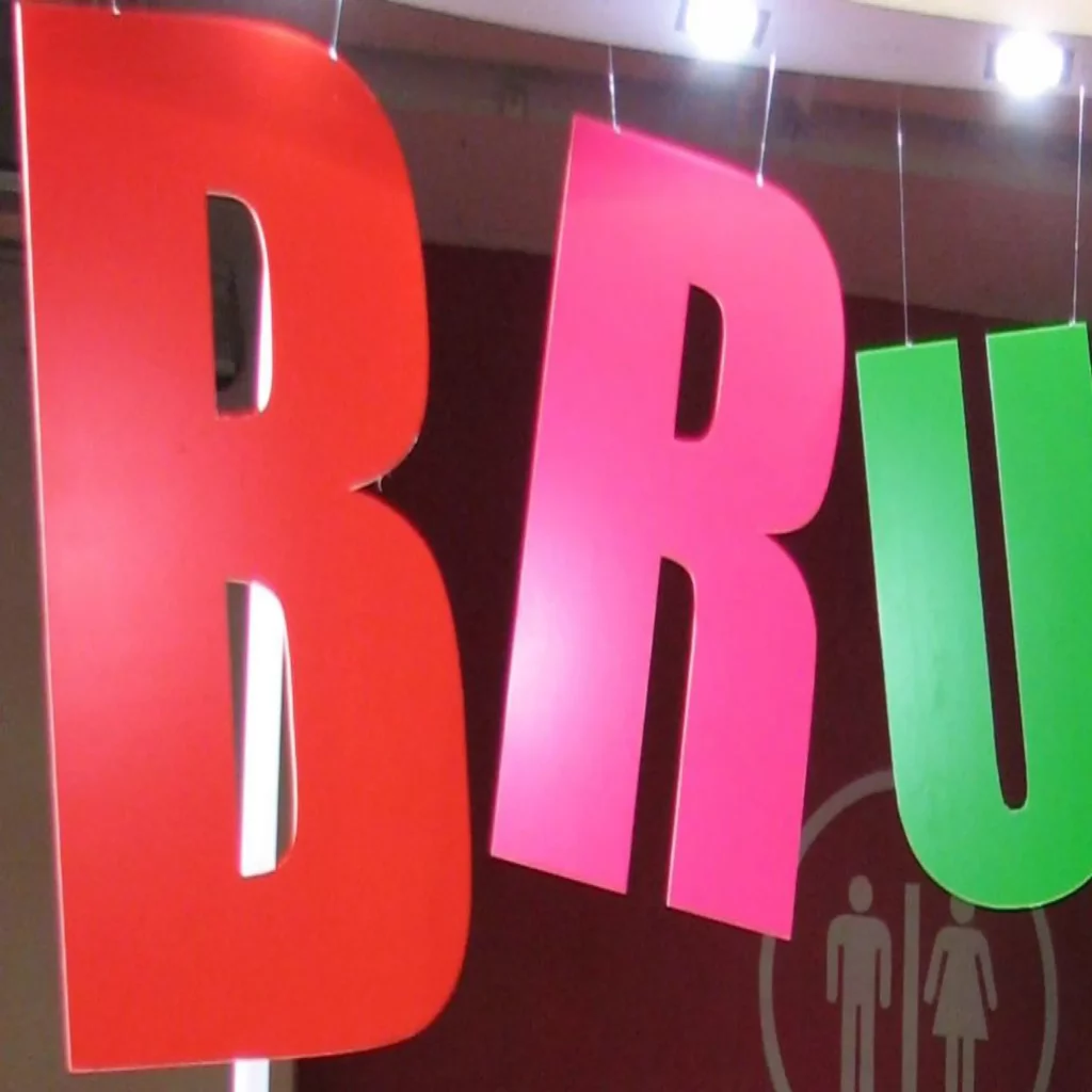 MACal 8000 fluorescent coloured self-adheive sign vinyls pictured here applied to cutout letters that are hung from the ceiling to create a brightly coloured hanging display that stands out from it's surroundings.