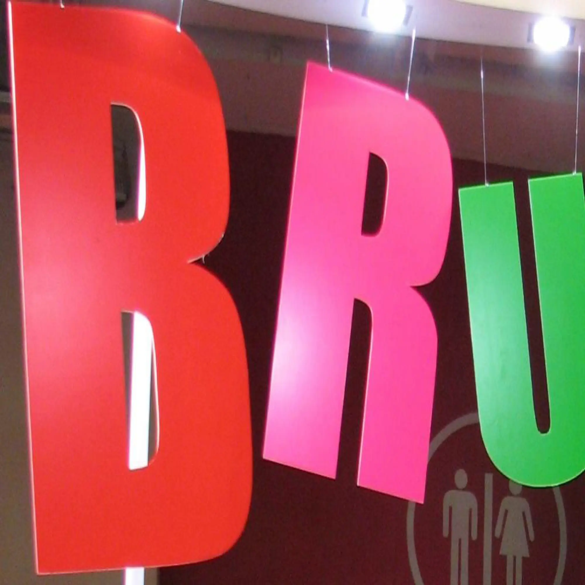 MACal 8000 fluorescent coloured self-adheive sign vinyls pictured here applied to cutout letters that are hung from the ceiling to create a brightly coloured hanging display that stands out from it's surroundings.