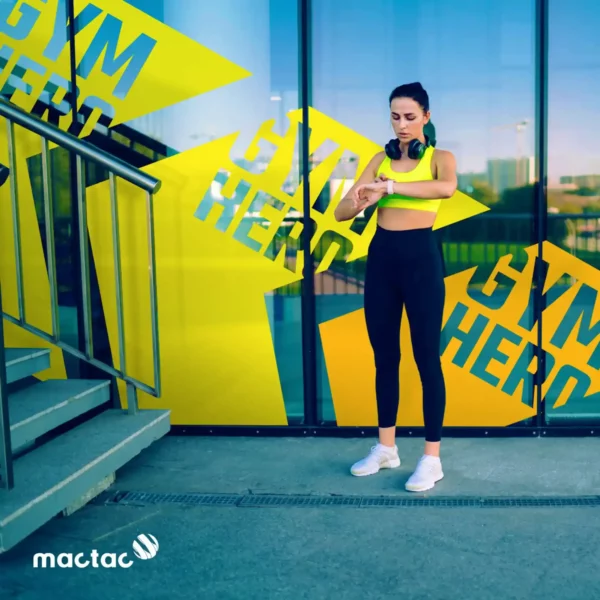 MACal 8200 coloured PVC self-adhesive calendered sign films from Mactac, used in this photo as cut-vinyl wayfinding signage for a gym.