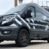 MACal 8300 used for cutout logo branding on the flat sides of a company delivery van, with additional vinyl sign graphics spaced around the logos for decorative effect.