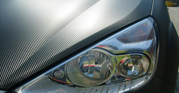 MACal Carbon Fibre BF Satin Black carbon fibre wrap film conformed over car bonnet with close up detail of the embossed textured finish.