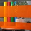 MACcrystal 8407-03 Orange tinted transparent window vinyl sample applied to an internal office window to show the level of transparency and the decorative colour transformation effect that this tint coloured self-adhesive film provides.