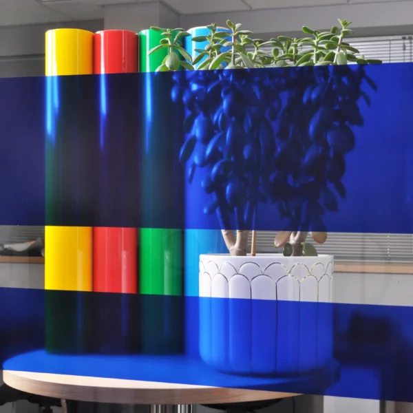 MACcrystal 8437-04 Deep Blue coloured window tint film applied to an internal office window to show the level of transparency and the colour transformation effect that this transparent decorative self-adhesive vinyl provides.