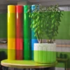 MACcrystal 8437-05 Yellow-Green self-adhesive decorative coloured window tint film sample applied to an internal office window to show the level of transparency and the decorative colour transformation effect that this bright and transparent vinyl offers.
