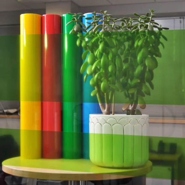 MACcrystal 8437-05 Yellow-Green self-adhesive decorative coloured window tint film sample applied to an internal office window to show the level of transparency and the decorative colour transformation effect that this bright and transparent vinyl offers.