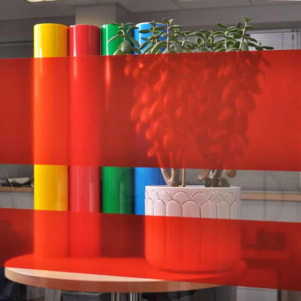 MACcrystal 8457-02 Light Red transparent colour tint window film sample applied to an internal office window to show the level of transparency and the decorative colour transformation effect that this bright self-adhesive vinyl offers.