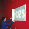 The stencil graphic has been weeded out and application tape applied on top to keep the stencil film in position during installation onto the graphics' surface.