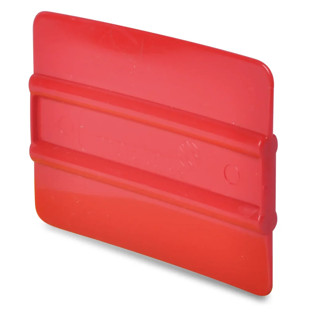 4 inch bright red ribbed soft plastic squeegee for applying self-adhesive vinyls and graphics films. Mactac branding is subtly embossed in the middle, between the two central gripping ribs.