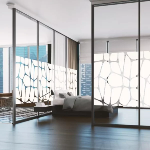 Mactac 700 Tints has been applied to a modern penthouses open-plan glass partition walls in an abstract, white leafy vein style pattern, providing privacy and obscurity to the bedroom space at the focus of this photo.