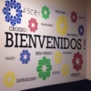 Mactac 8200 colour sign vinyl cut lettering assembled onto a reception wall spelling out "welcome" in a dozen or more languages in different sizes and bright colours.