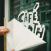 Removing application tape from cut vinyl window decal graphics.