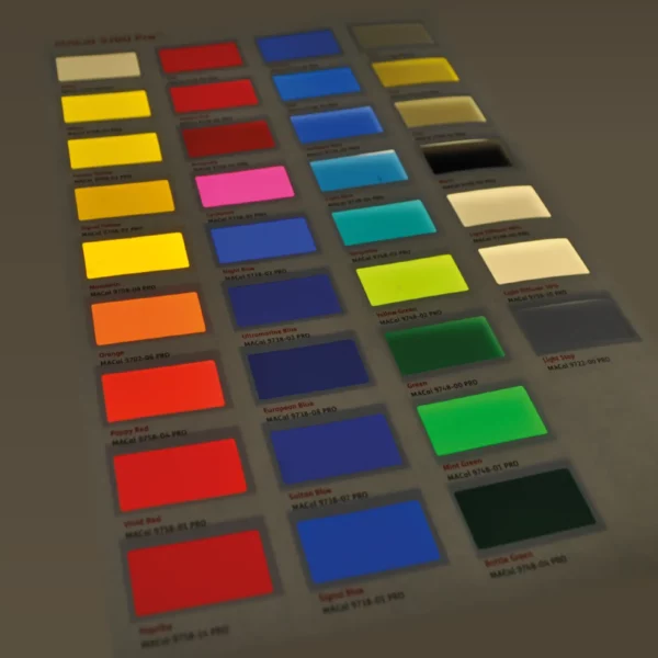 The colour card for Mactac 9700 coloured lightbox films placed onto a graphics lightbox with the backlit illuminated colours shining out as the light travels through the translucent colours, really making them stand-out from the dark background surrounding the samples.