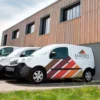 Mactac 9800 coloured self-adhesive vinyls have been used to decorate the sides of a fleet of white company vehicles with logos and other simple corporate cut-vinyl coloured branding.