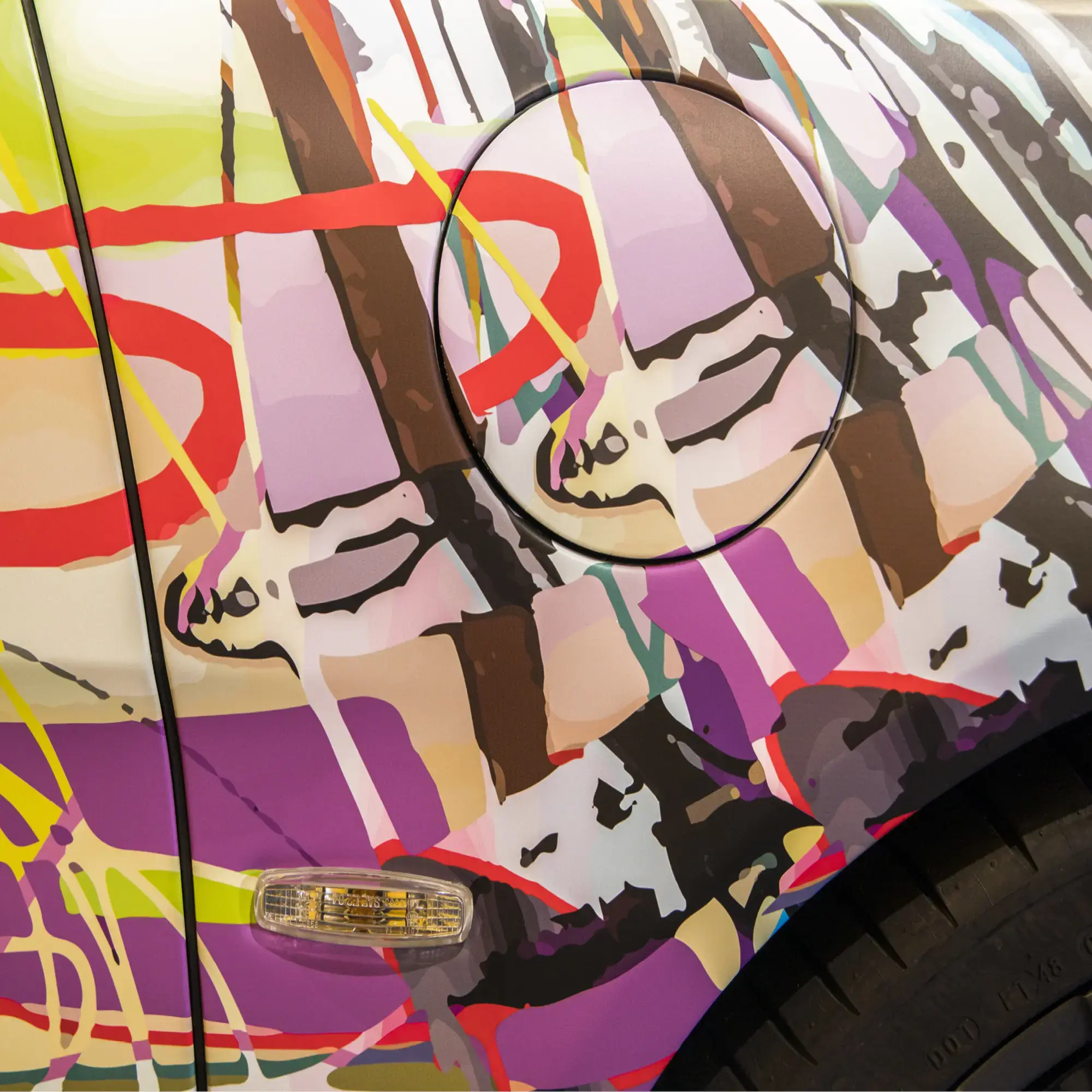 Mactac cast wrap films LF 10700 CM-UV and matched print vinyl JT 10700 WG-BFG-XR with a focus on the abstract car wrap design contoured around the intricate rear side light, wheel arch and petrol cap areas.