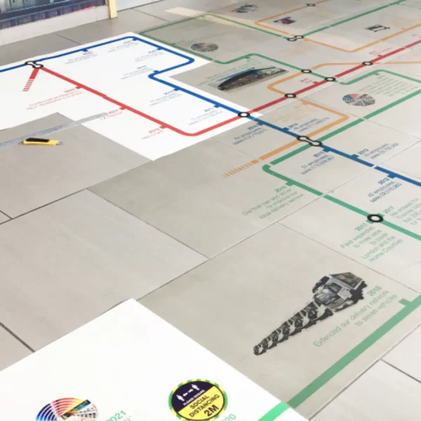Mactac Permaflex Floorgrip tube-map styled graphic, printed with UV ink, is in the process of being applied to this reception floor area. Some of the prints are already stuck in position while others remain on their white liner waiting to be installed onto the internal ceramic tiles.