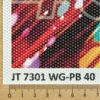 A section of Mactac JT 7301 WG-PB 40 one-way vision window film is displayed next to a ruler, highlighting its 60/40 hole ratio. The close-up view shows the perforation pattern designed to balance bold exterior graphics with interior visibility. NOTE: The photo shown has the white face film still on it's white backing release liner, so the holes/perforations are not see-thru until the liner has been removed.