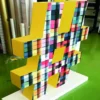 Mactac JT 8500 WG-PG self-adhesive print vinyl applied to large 3D letters for a short term festival art installation has been printed with a vibrant coloured abstract block pattern.