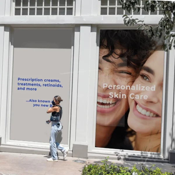 Mactac JT 8700 WG-RG grey opaque removable adhesive wide-format print film pictured here printed with "personalized skin care" promotional display poster advertising graphics and applied to large pharmacy shop front windows.