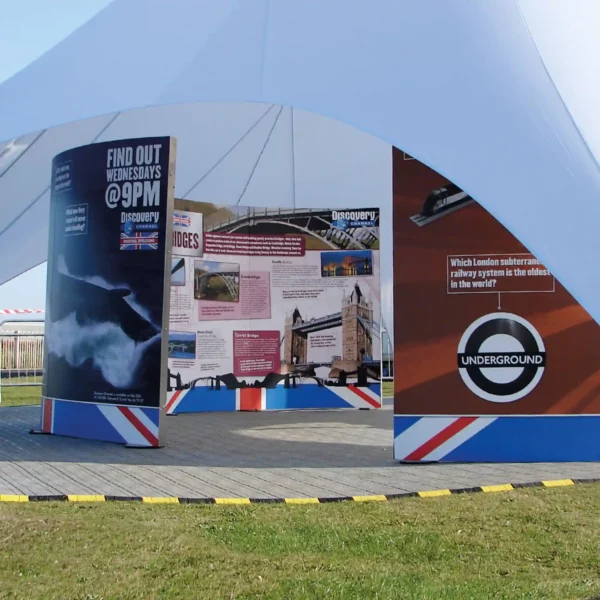 Mactac JT 8700 WM-PG self-adhesive digital printing vinyl for applications onto flat surfaces is pictured here applied onto 3 large semi-circular exhibition boards situated under a marquee tent at an outdoor event.