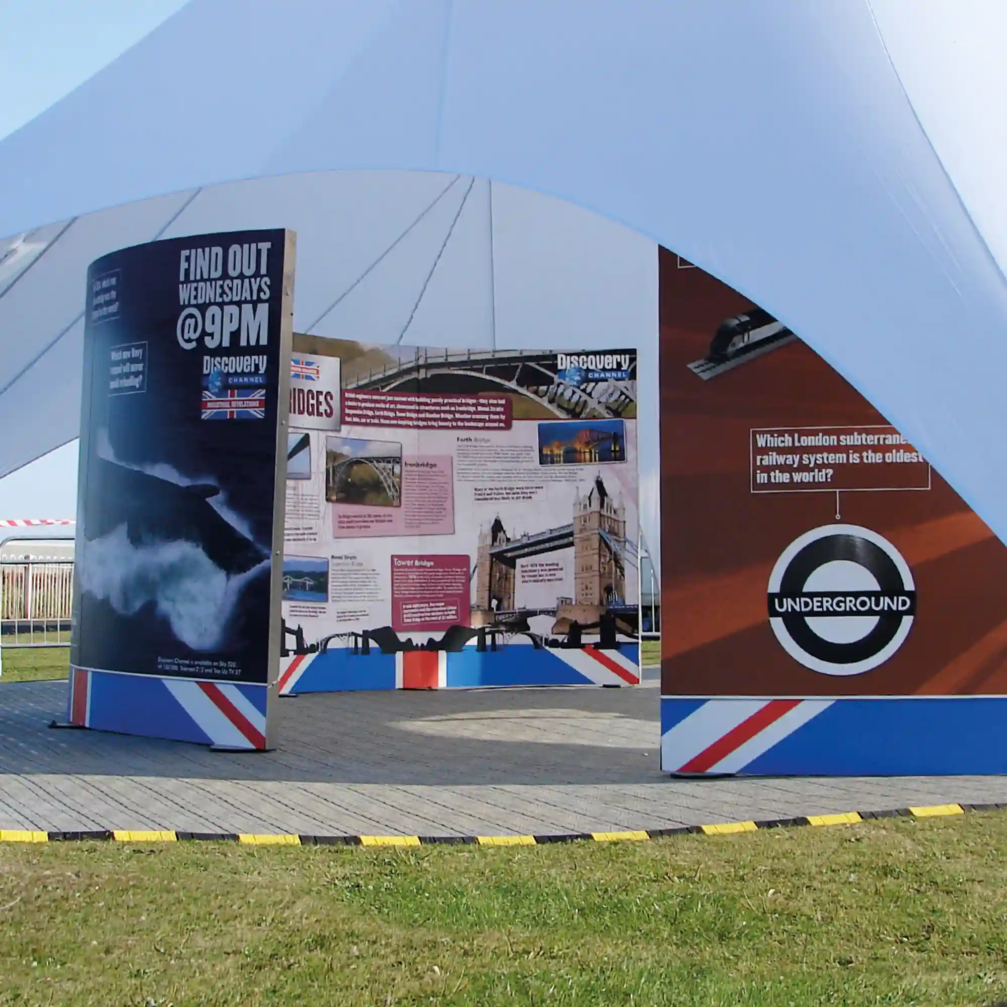 Mactac JT 8700 WM-PG self-adhesive digital printing vinyl for applications onto flat surfaces is pictured here applied onto 3 large semi-circular exhibition boards situated under a marquee tent at an outdoor event.