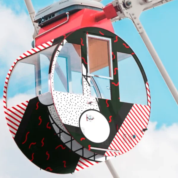 Mactac JT 9500 and JT 9700 polymeric series of high quality self-adhesive print vinyls applied to decorate the exterior of this funfair ferris wheel with colourfully printed abstract strpies and dot patterns in black, white and red.