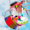 JT 9500 and JT 9700 series of high quality self-adhesive polymeric print vinyls that have been applied to decorate the exterior of this fairground ride in printed dots and swirls patterns in red, white, lime green, blue and purple shapes.