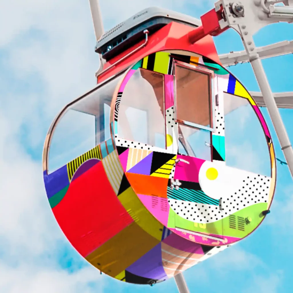 JT 9500 and JT 9700 series of high quality self-adhesive polymeric print vinyls that have been applied to decorate the exterior of this fairground ride in printed dots and swirls patterns in red, white, lime green, blue and purple shapes.