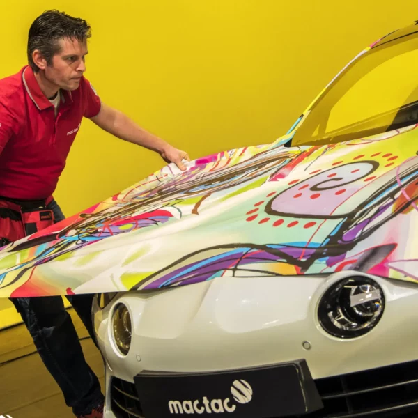 Positioning a printed and laminated vehicle wrap graphic over the bonnet of a modern car with its curvy contours.