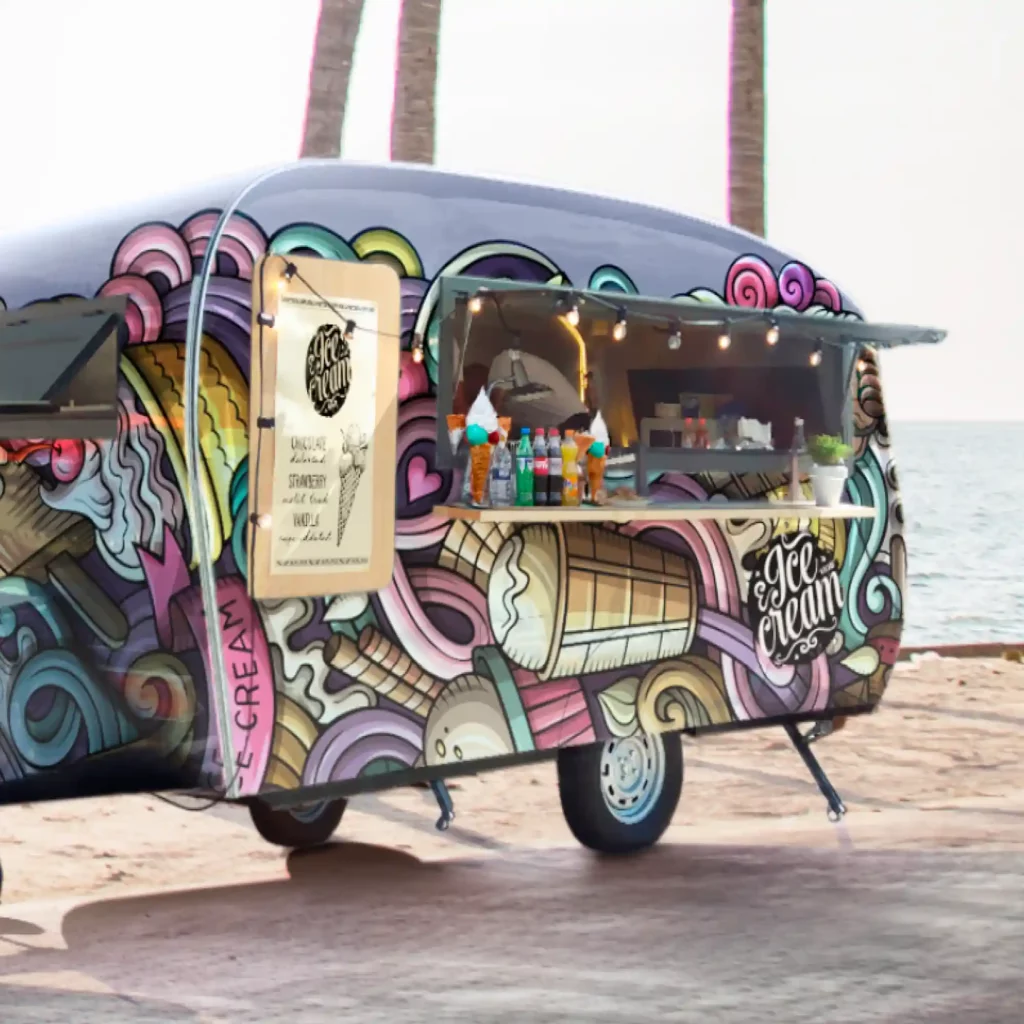 Mactac LF 9500 CG-UV, clear gloss graphics laminate protecting the printed design of ice-creams and rainbow sirlw patterns that is applied to all sides of an ice cream caravan that is parked on a beach front with palm trees in the background.