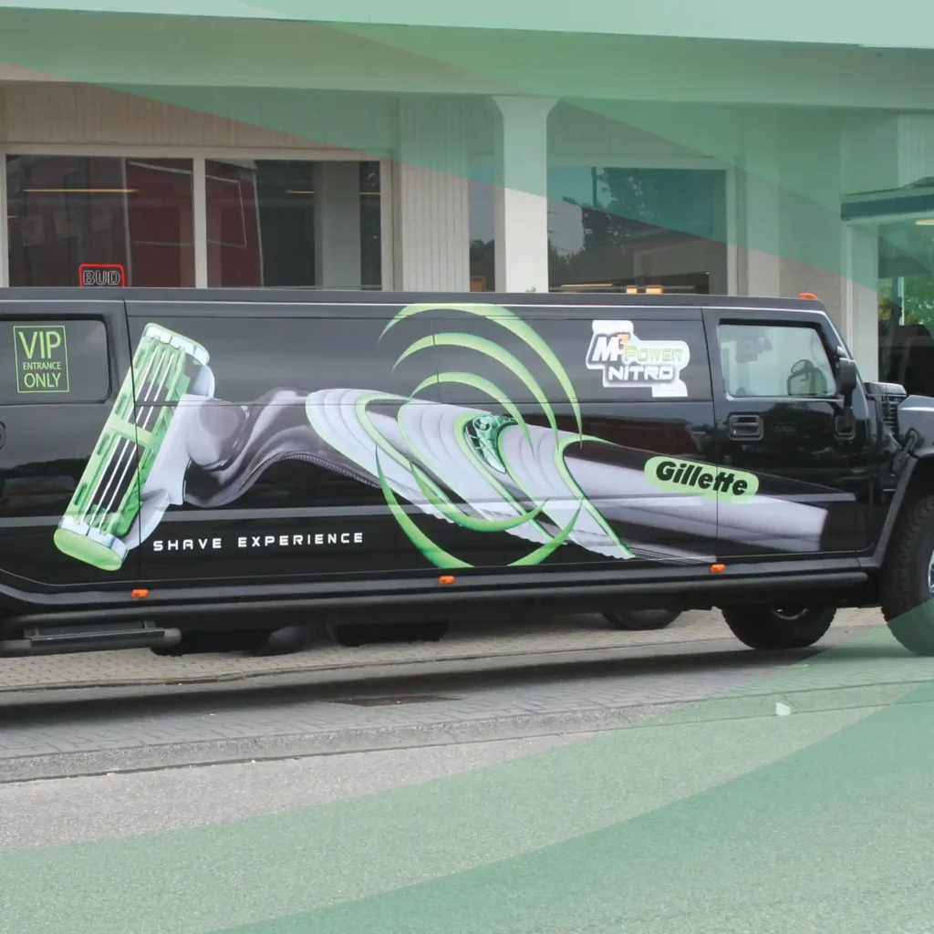 Mactac LF 9700 CM-UV polymeric matt graphics laminate covering a printed promotional graphic on the flat vehicle sides of a VIP, luxury chauffeur-driven Humvee limousine.