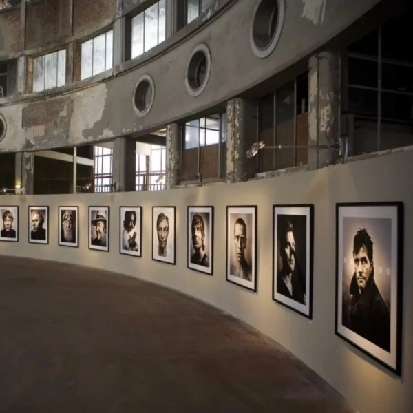 Exhibition graphic prints of various peoples portrait photos mounted within an old industrial setting that have been finished with Mactac LF8500 CM clear matt monomeric graphics laminate providing a professional, glare-free look that offers the images in their best light.