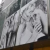 Mactac LF 8700 CG-UV gloss clear graphics laminate protecting a large retail store advertising promotional fashion print above a high rise city retail entrance.