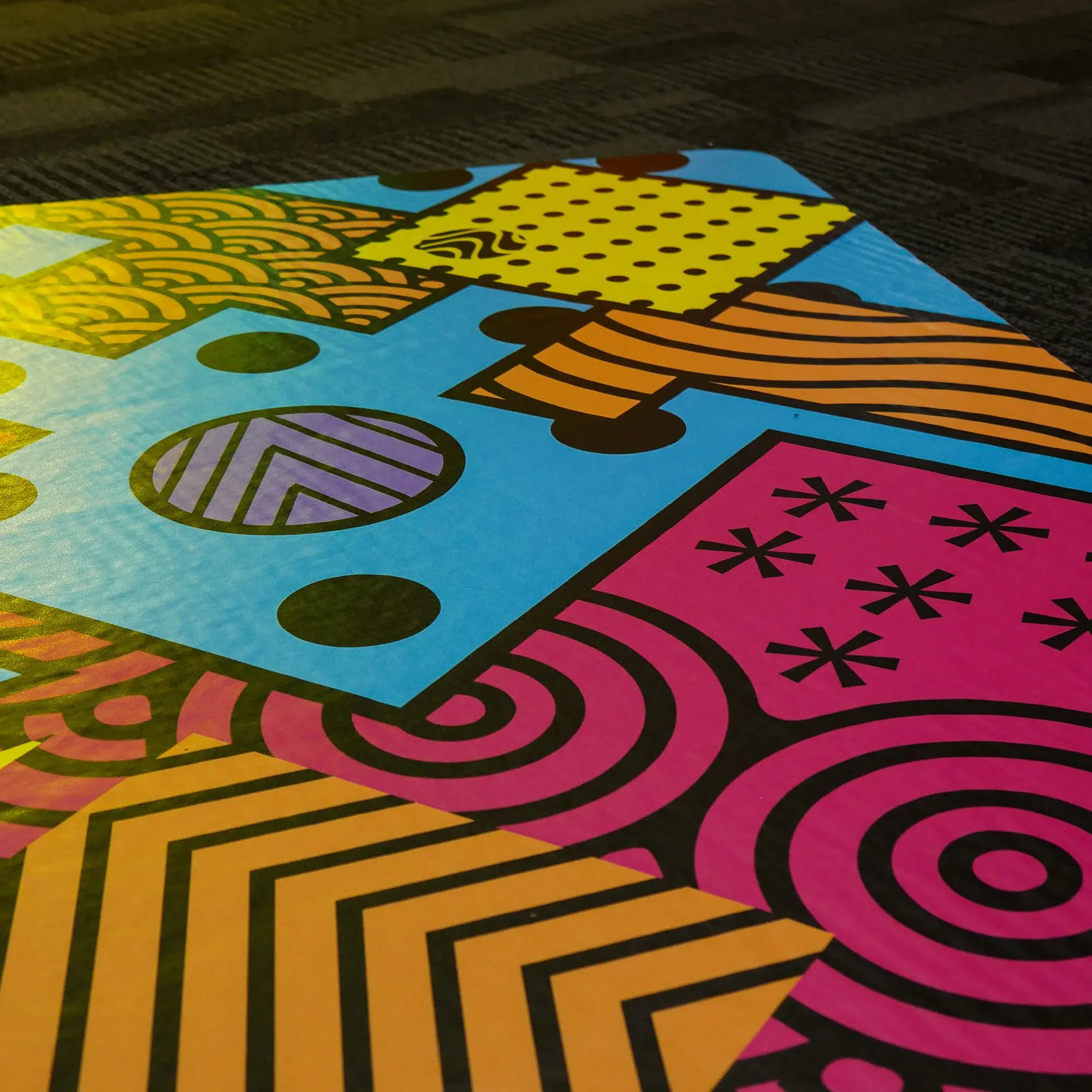 Printed floor graphic laminated with Mactac LUV 6300 and applied to an internal carpet for decorative, promotional and wayfinding purposes.