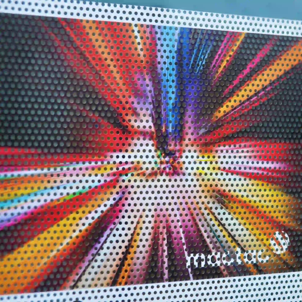 A close-up of Mactac JT 7300 WG-PB 30 one-way vision perforated white window print film, featuring a 70/30 hole pattern. The white-faced film is designed for vivid, high-impact graphics on glass surfaces while maintaining one-way visibility and interior light entry.