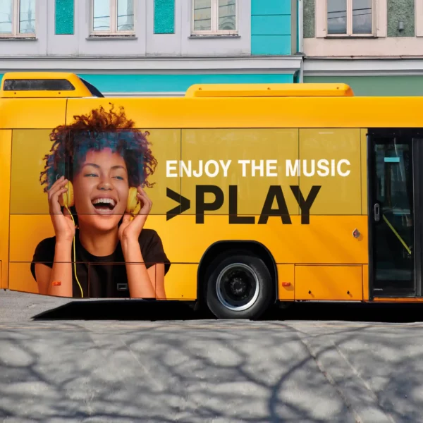 Mactac JT 7301 WG-PB 40 one-way vision film applied to bus windows, displaying vibrant exterior graphics while preserving passenger visibility from inside. The 60/40 perforation ratio ensures strong visual impact for transit advertising without compromising interior light or views.