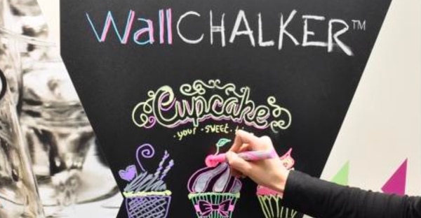 Wallchalker blackboard film being chalked onto creating a stylish chalkboard sign advertising cupcakes.