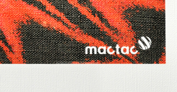 WW Canvas textured pattern white self-adhesive wall print vinyl is shown in close up, detailing the printed and unprinted areas of a sample of the material with the canvas emboss of the print media. The printed part of the sample shows the a bright, colourfull black and red butterfly wing image with the Mactac brand logo in the bottom right corner. At the very bottom of the image you can see the pattern of the unprinted satin white base material.
