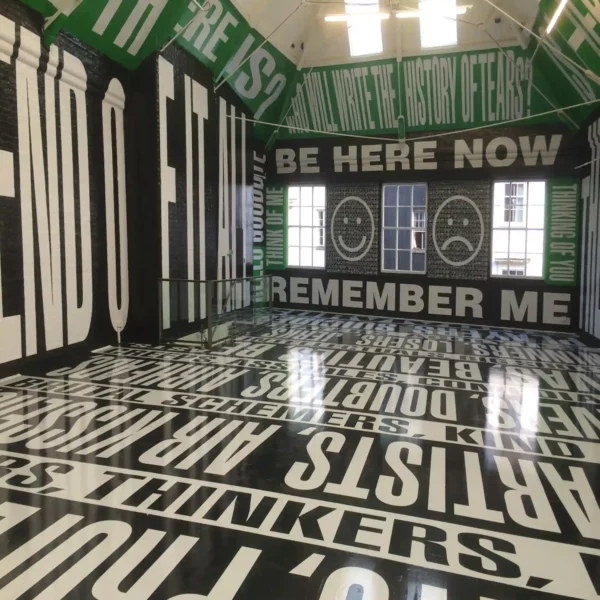Mactac WW100 Pro printed self-adhesive film displaying 'Be Here' and other English text phrases as large text black, green and white colour themed prints that are applied from ceiling to floors onto internal brick walls.