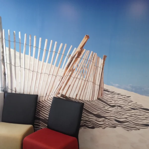 Mactac WW200 self-adhesive wall covering vinyl printed with a fenced sand dune scene, installed in a waiting room setting.