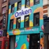 Onken brand graphics printed on Mactac WW300 self-adhesive vinyl sticks to difficult surfaces and has been applied here to decorate a full building frontage over 3 storeys high.